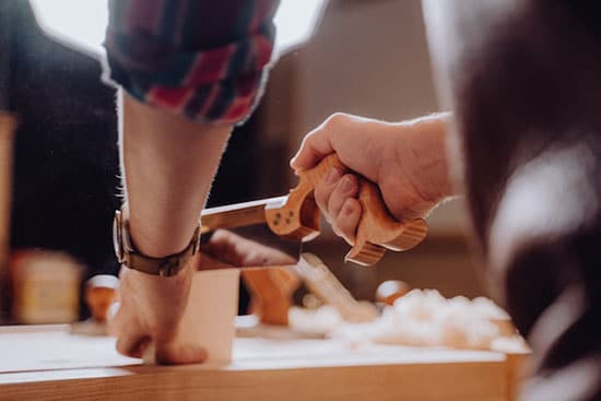 wood worker cutting wood